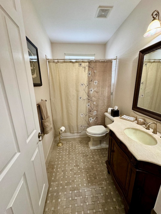 full bathroom with vanity, toilet, and shower / tub combo