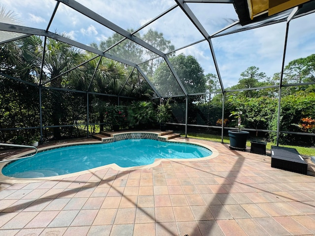 view of pool with a patio and a lanai