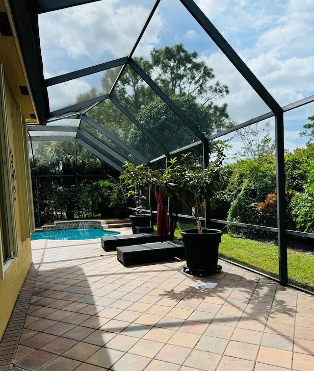 view of patio with glass enclosure