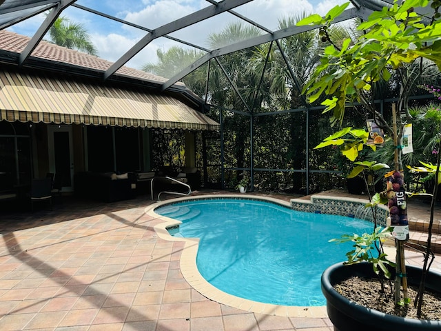 view of pool with pool water feature, a patio area, and glass enclosure