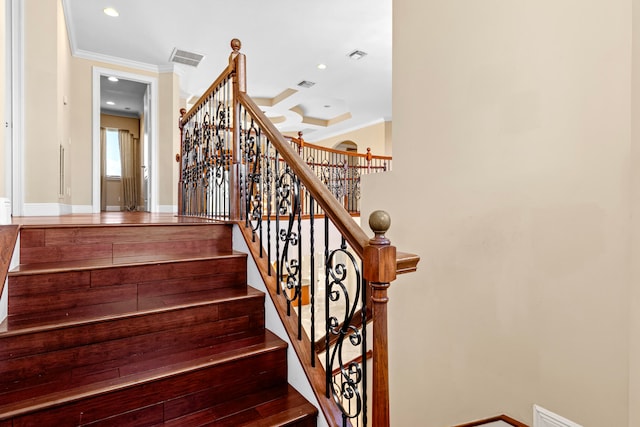 stairway featuring hardwood / wood-style floors and crown molding