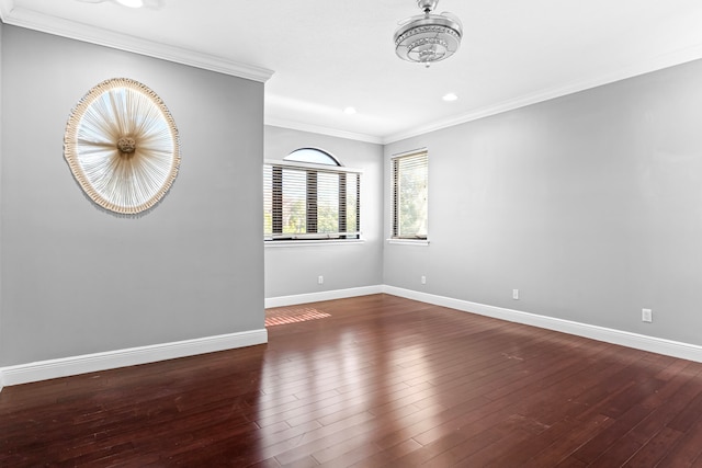 empty room with crown molding and dark hardwood / wood-style flooring