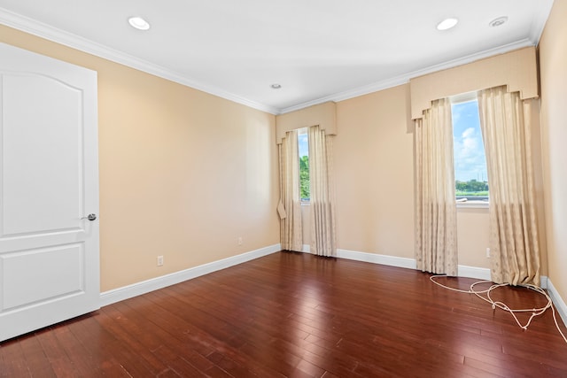 empty room featuring ornamental molding and dark wood-type flooring