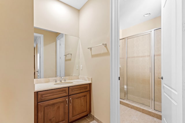 bathroom with vanity, walk in shower, and tile patterned floors