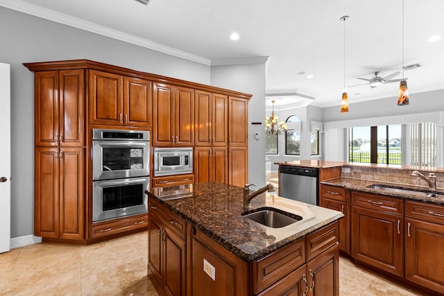 kitchen with sink, an island with sink, stainless steel appliances, and dark stone counters