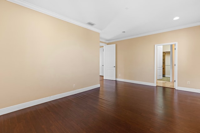 empty room with ornamental molding and dark hardwood / wood-style flooring