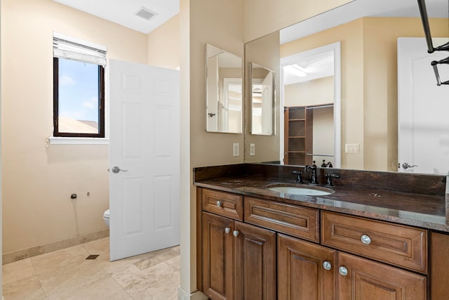 bathroom with toilet and vanity