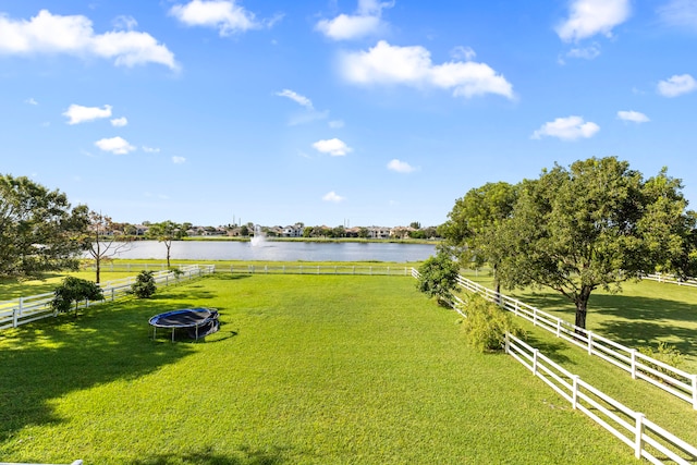 view of yard with a rural view and a water view