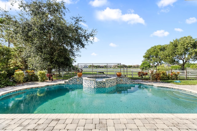 view of swimming pool with an in ground hot tub