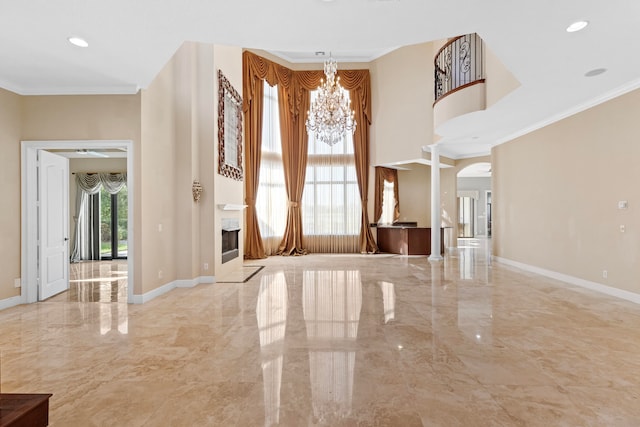 foyer featuring an inviting chandelier, crown molding, and a healthy amount of sunlight