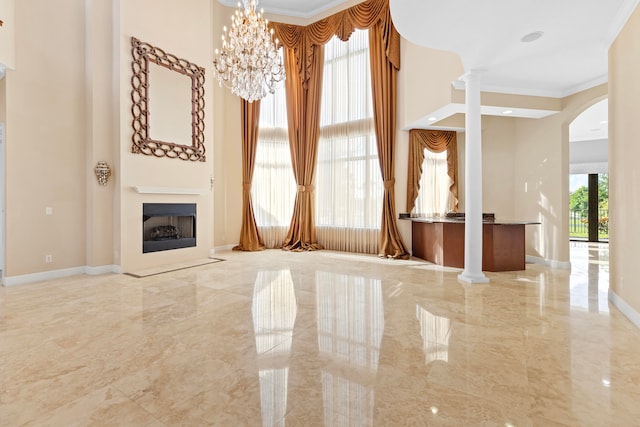 unfurnished living room with crown molding and an inviting chandelier