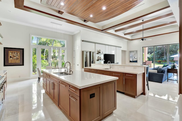 kitchen with a large island, sink, decorative light fixtures, and wooden ceiling