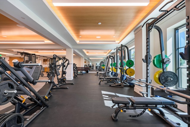 exercise room featuring a tray ceiling and wooden ceiling