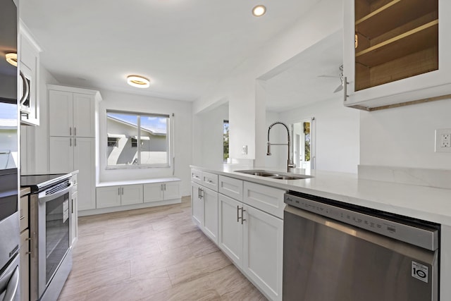 kitchen with white cabinetry, sink, and appliances with stainless steel finishes