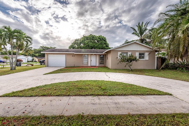 single story home featuring a garage and a front lawn