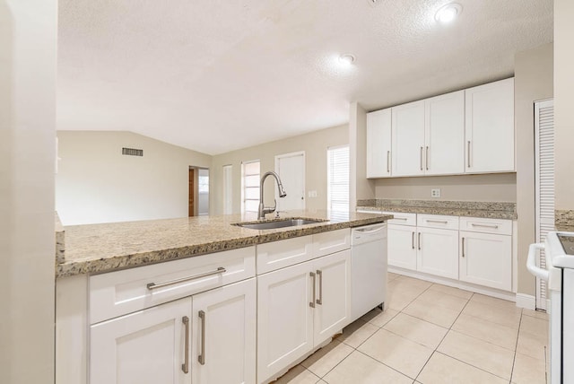 kitchen featuring white cabinets, a textured ceiling, vaulted ceiling, dishwasher, and sink