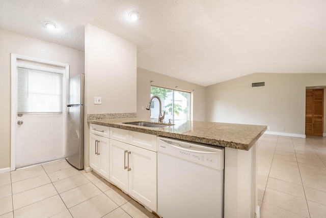 kitchen with lofted ceiling, white dishwasher, stainless steel fridge, sink, and white cabinets