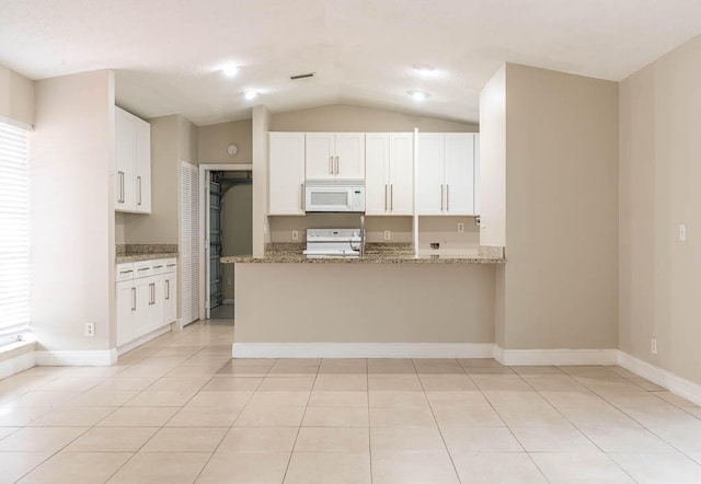 kitchen with lofted ceiling, stone countertops, kitchen peninsula, and white cabinetry