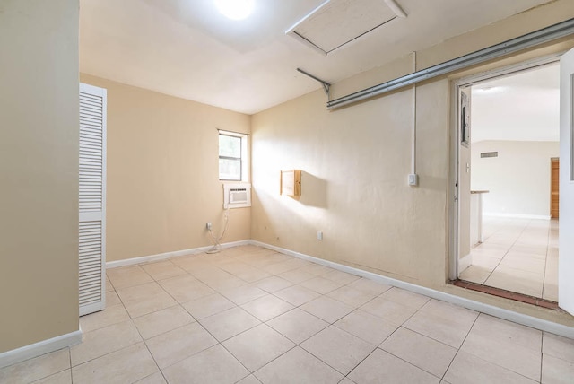 tiled spare room featuring lofted ceiling and a wall mounted AC