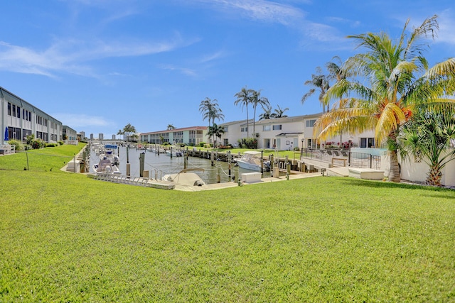 view of yard featuring a dock and a water view