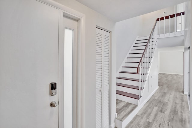 stairway with hardwood / wood-style flooring