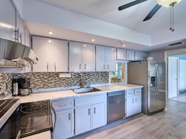 kitchen featuring decorative backsplash, ceiling fan, sink, and stainless steel appliances