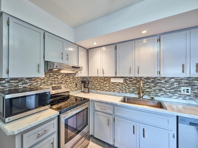 kitchen featuring gray cabinetry, decorative backsplash, sink, and stainless steel appliances