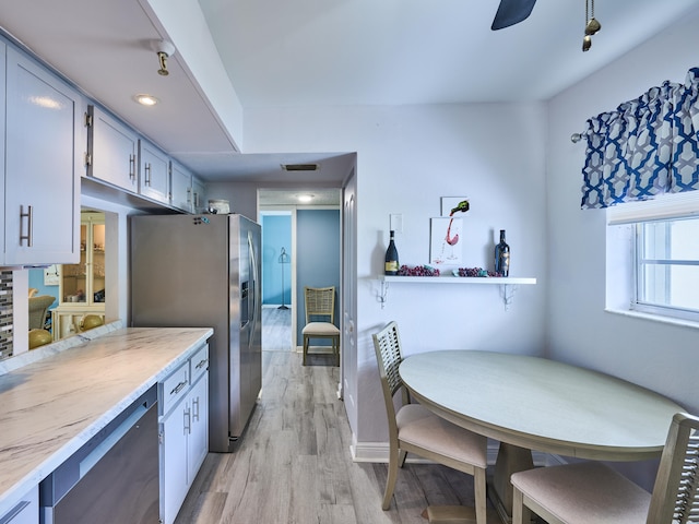 kitchen with stainless steel appliances and light hardwood / wood-style flooring