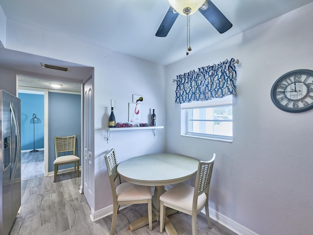 dining area featuring hardwood / wood-style floors and ceiling fan