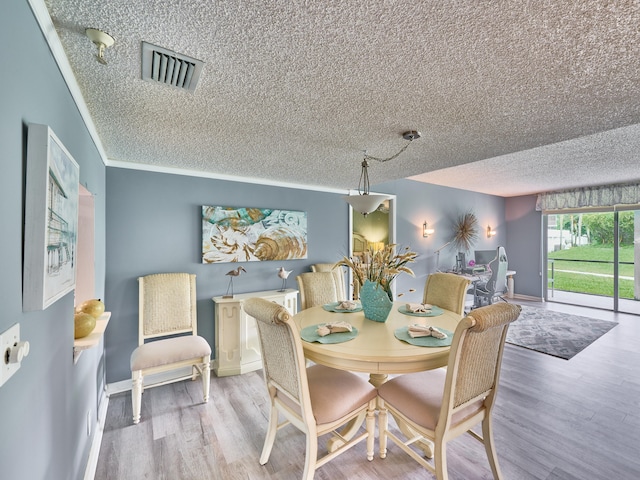 dining room featuring crown molding and wood-type flooring