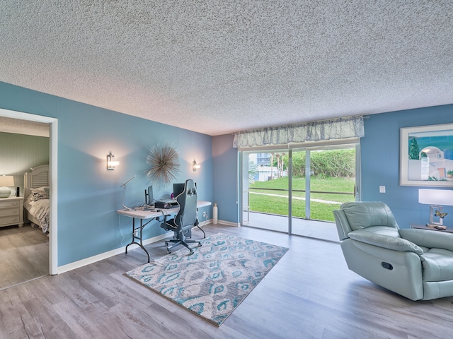 office space with light hardwood / wood-style floors and a textured ceiling