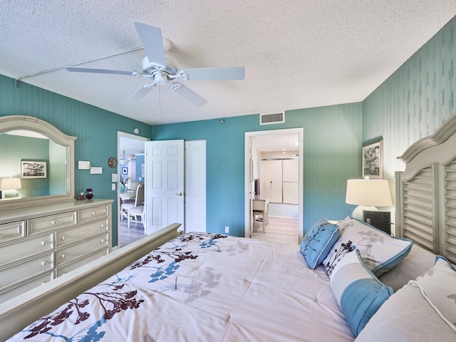 bedroom with a textured ceiling and ceiling fan