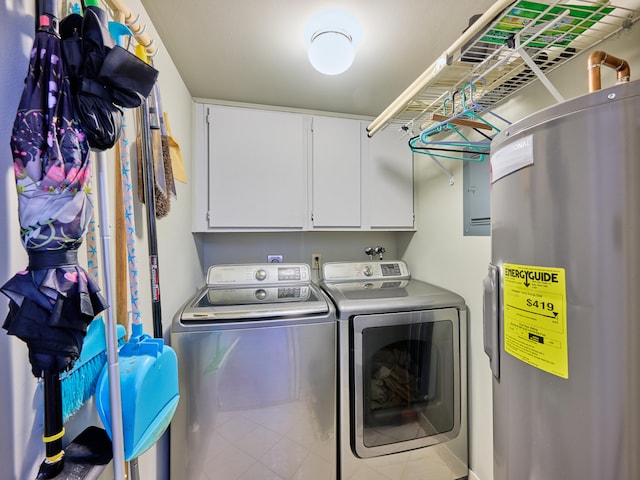 clothes washing area with washer and clothes dryer, cabinets, and electric water heater