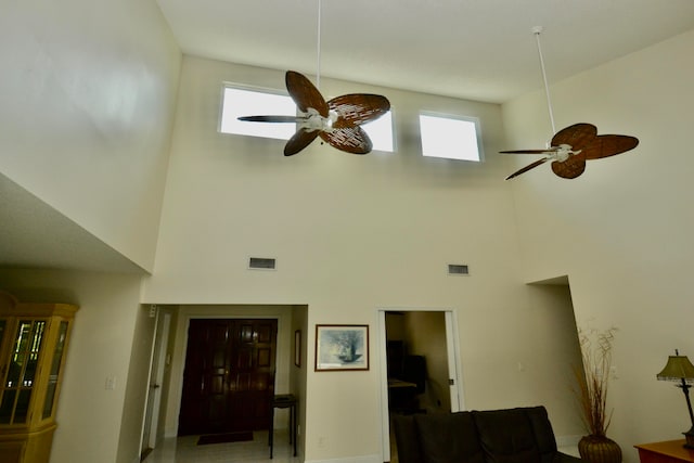 living room with a towering ceiling and plenty of natural light