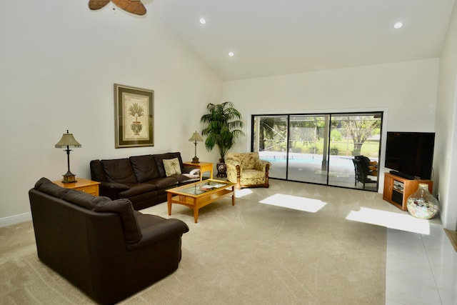 living room featuring ceiling fan, high vaulted ceiling, and light tile patterned floors