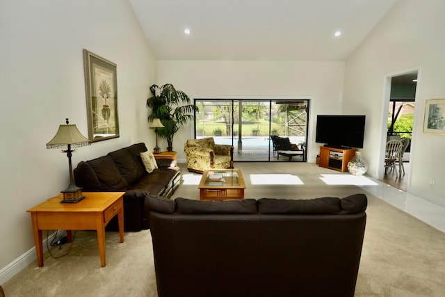 carpeted living room featuring high vaulted ceiling