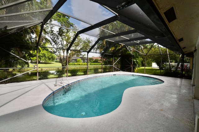 view of swimming pool featuring a patio area, a water view, and a lanai