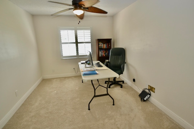 office space featuring light carpet and ceiling fan