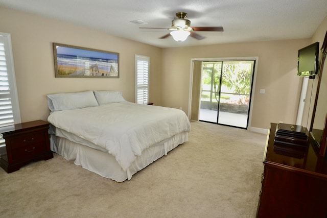 carpeted bedroom featuring a textured ceiling, access to exterior, and ceiling fan