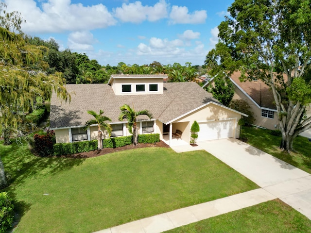 view of front of home featuring a garage and a front lawn