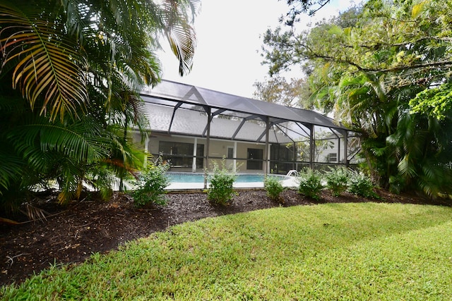 view of yard with glass enclosure