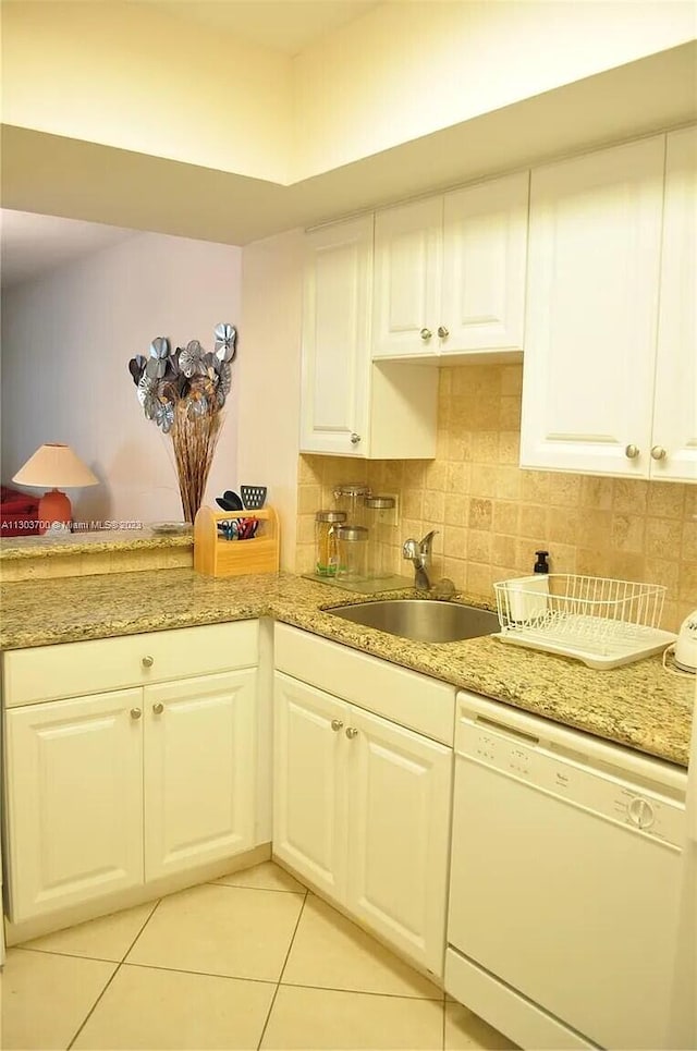 kitchen featuring white cabinetry, sink, and white dishwasher