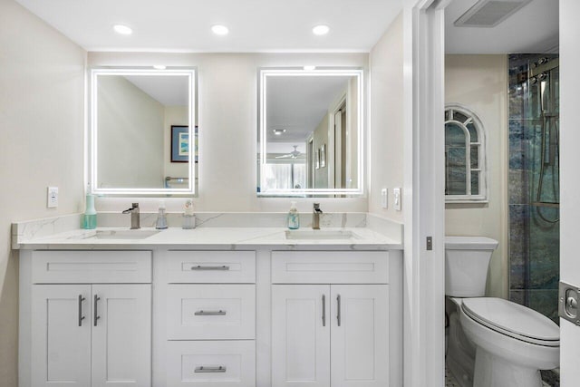 bathroom featuring vanity, toilet, and a shower with shower door