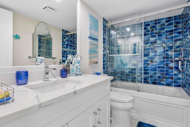 full bathroom with vanity, toilet, tile patterned flooring, and bath / shower combo with glass door