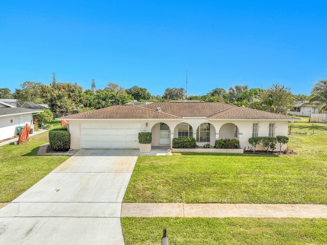 view of front of house featuring an attached garage, a front yard, concrete driveway, and stucco siding