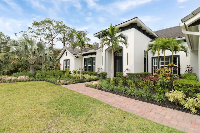 mediterranean / spanish house featuring a front lawn