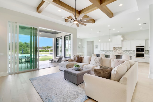 living room featuring ceiling fan, beamed ceiling, light hardwood / wood-style floors, and coffered ceiling