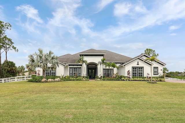 mediterranean / spanish house with french doors and a front lawn