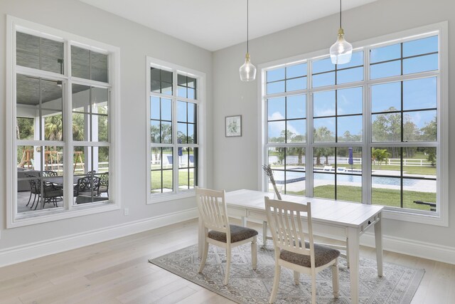 kitchen featuring a large island, a barn door, sink, and light hardwood / wood-style flooring