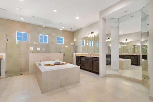 bathroom featuring tile patterned flooring, vanity, tile walls, and shower with separate bathtub